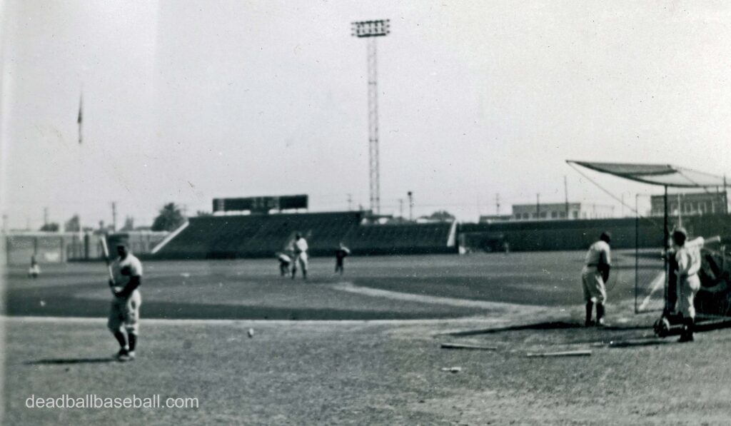 A black and white image of baseball players in the Wrigley Field stadium