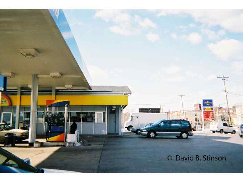 A gas station with parked cars