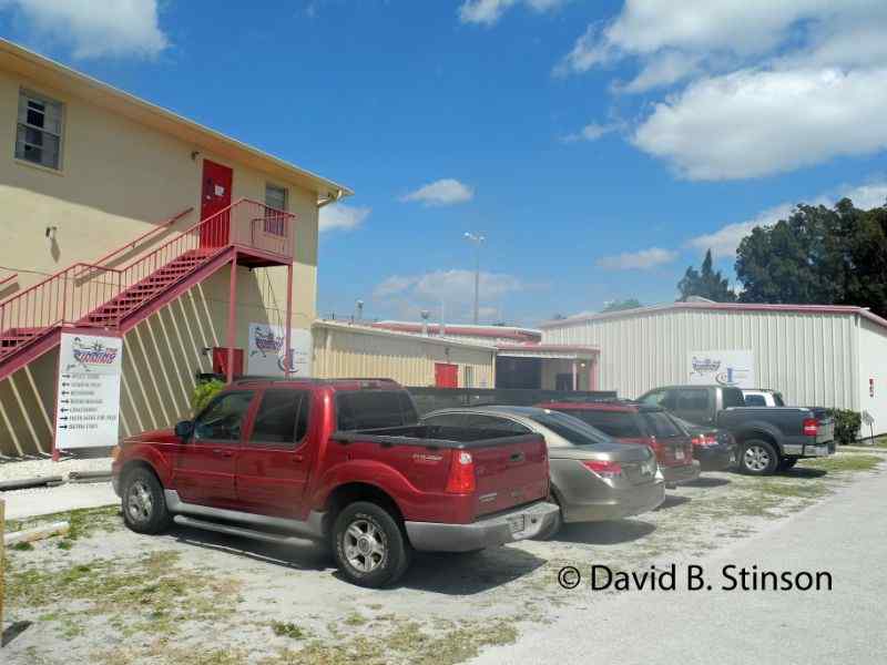 Cars parked along a Jack Russel Stadium building