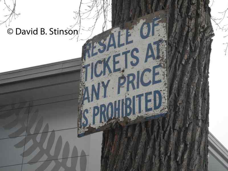 An old ticket resale warning sign