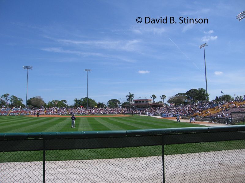 A view of the players and the game from outside the Holman Stadium field