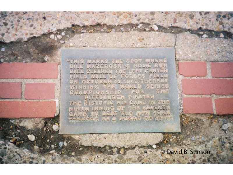 A bronze plaque in the sidewalk